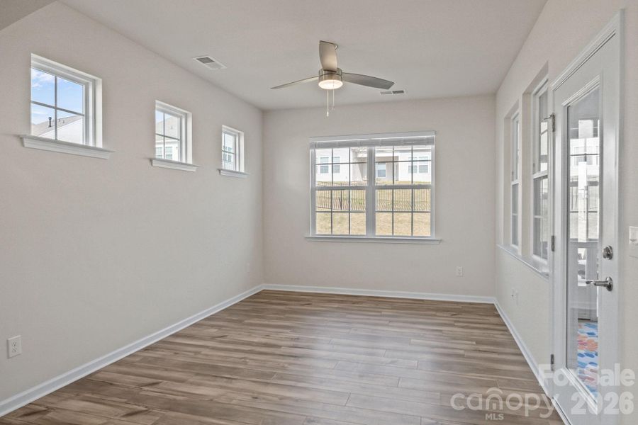 Through the arched entry to ....you decide how you wish to use this! An intimate sitting area?  Dining/breakfast room?  Glass door leads directly to your outside haven -- a large fully-screened covered porch room!