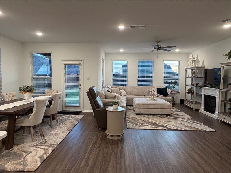 Luxury Vinyl Plank Flooring Flows Throughout the Main Areas, while a Wall of Windows Across the Back of the Home Fills the Space with Natural Light