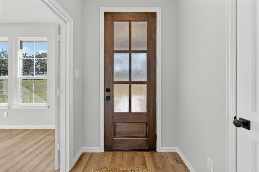 Entryway with baseboards and wood finished floors Entryway with baseboards and wood finished floors