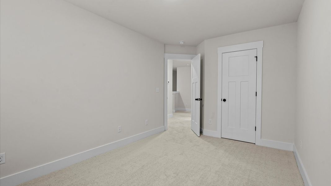 First-rate secondary bedroom with a spacious walk-in closet and elegant carpeted flooring