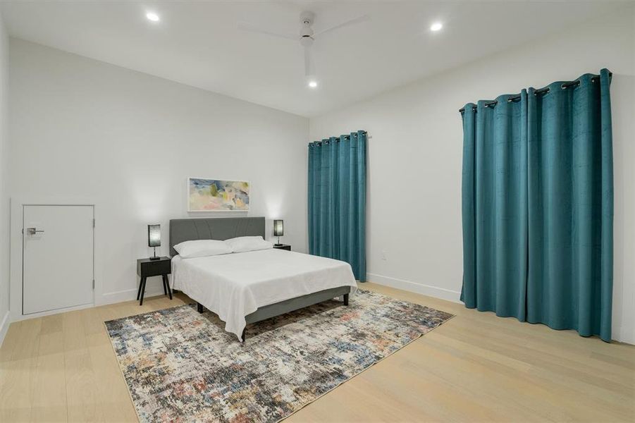 Bedroom with light wood-style floors, ceiling fan, and recessed lighting Bedroom with light wood-style floors, ceiling fan, and recessed lighting
