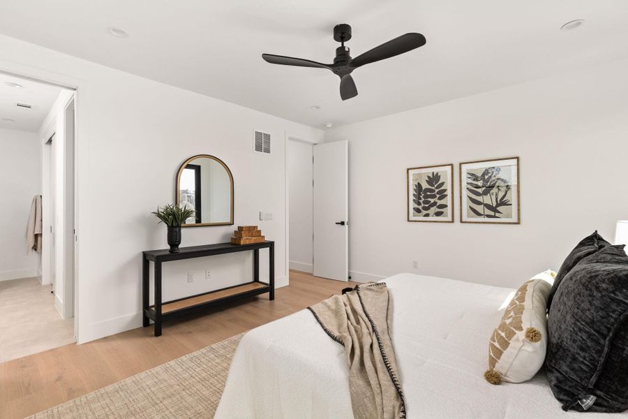 Bedroom with light wood finished floors and ceiling fan