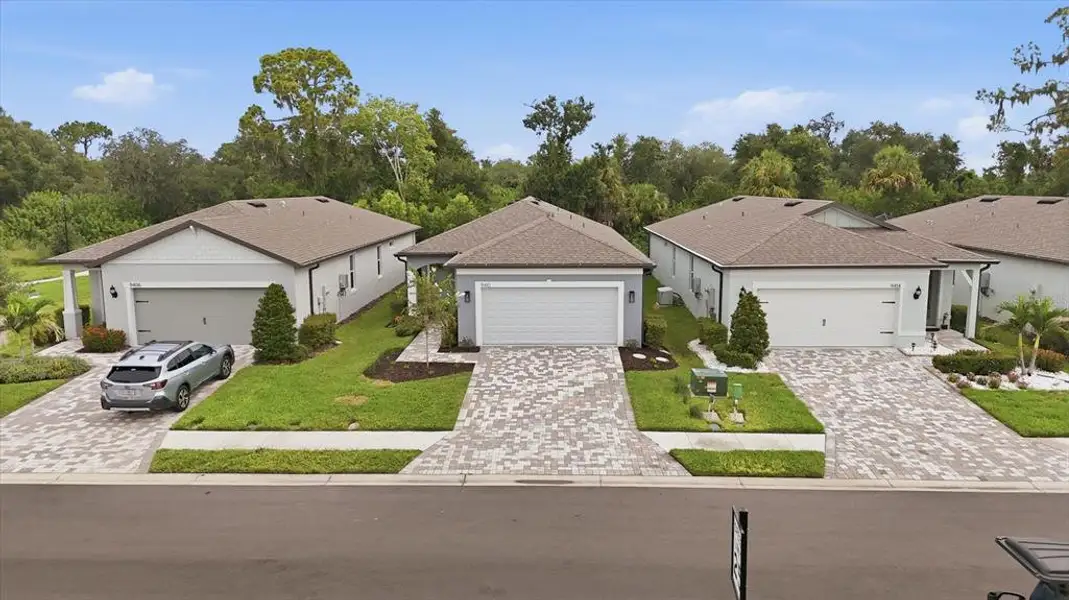 Front exterior of a new home in Del Webb BayView, Parrish, FL, highlighting curb appeal (Image 22). Front exterior of a new home in Del Webb BayView, Parrish, FL, highlighting curb appeal (Image 22).