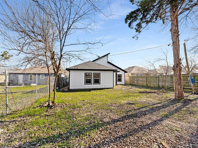 Rear view of property featuring a lawn