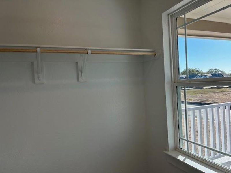 Walk-in secondary closet with a window