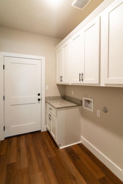 Washroom featuring cabinet space and washer hookup
