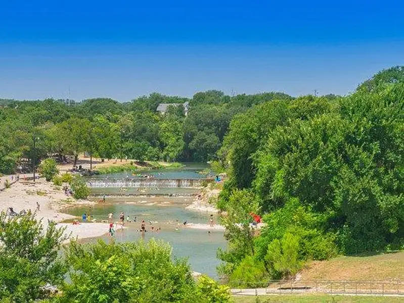 View of property's community with a water view and a wooded view
