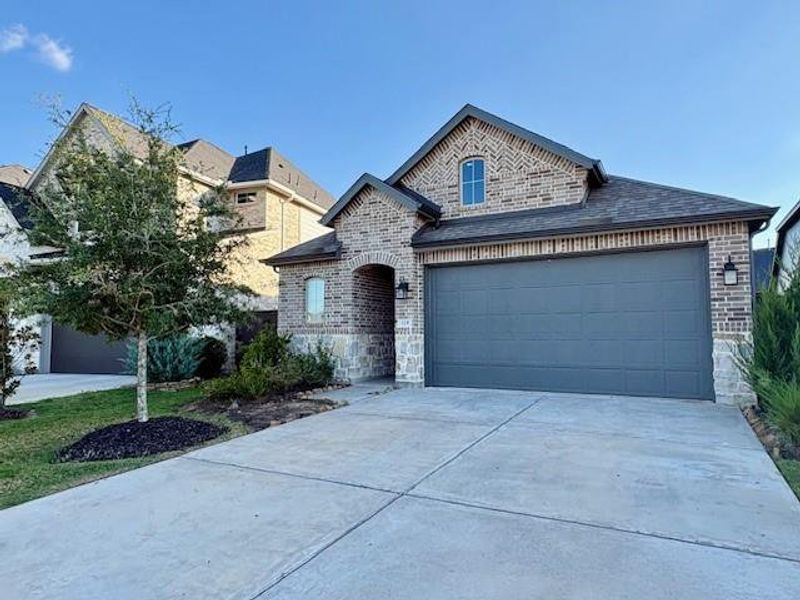 Front exterior of a new home in , Richmond, TX, highlighting curb appeal (Image 1). Front exterior of a new home in , Richmond, TX, highlighting curb appeal (Image 1).
