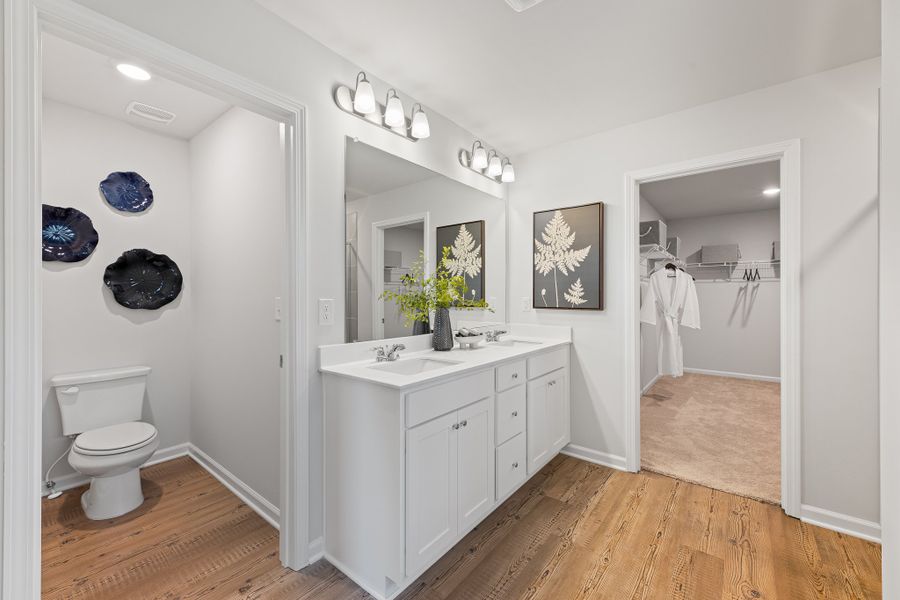 A bathroom with a toilet and sink. A bathroom with a toilet and sink.