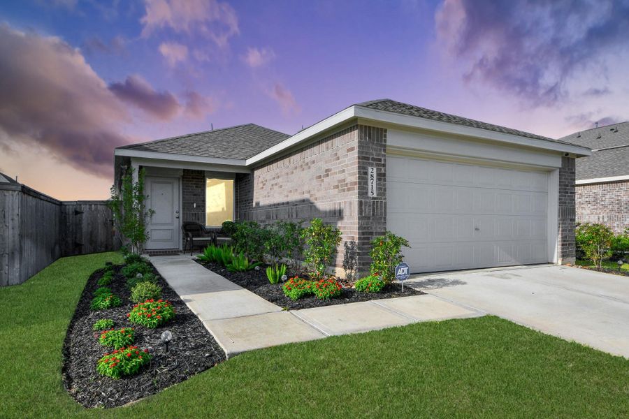 Front exterior of a new home in The Grand Prairie, Hockley, TX, highlighting curb appeal (Image 15). Front exterior of a new home in The Grand Prairie, Hockley, TX, highlighting curb appeal (Image 15).