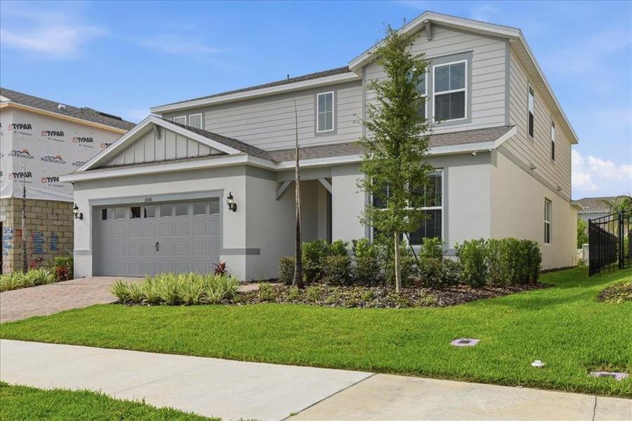 Front exterior of a new home in Willow Ridge, Montverde, FL, highlighting curb appeal (Image 2). Front exterior of a new home in Willow Ridge, Montverde, FL, highlighting curb appeal (Image 2).