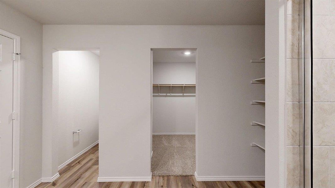 Integrated storage solutions featuring an open closet with built-in shelving and a walk-in closet with recessed lighting and additional shelving
