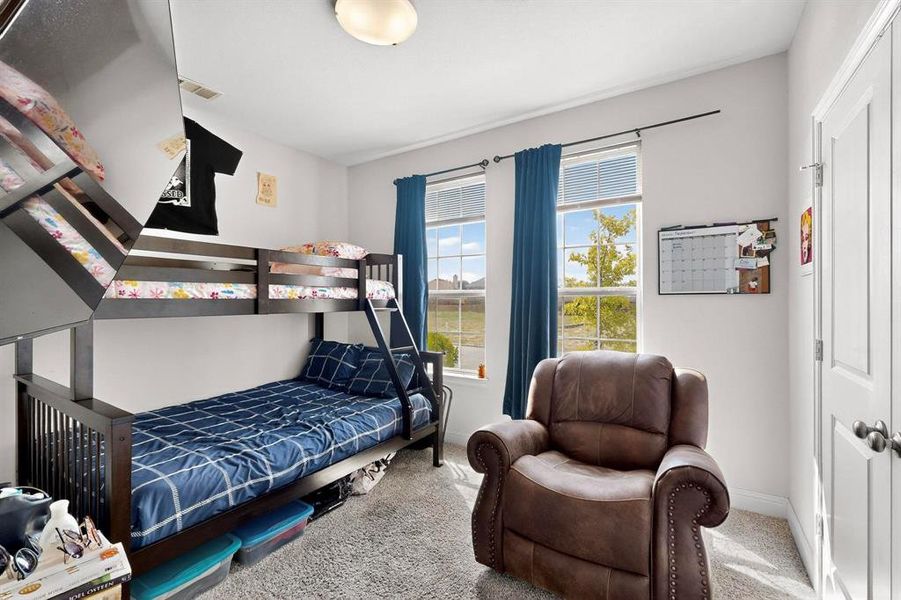 Carpeted bedroom featuring baseboards Carpeted bedroom featuring baseboards