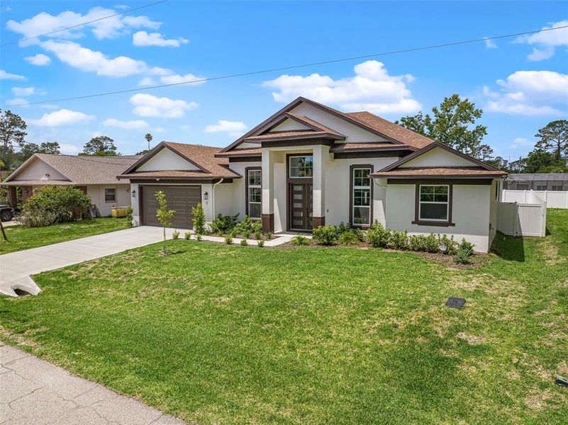Front exterior of a new home in , Palm Coast, FL, highlighting curb appeal (Image 24). Front exterior of a new home in , Palm Coast, FL, highlighting curb appeal (Image 24).