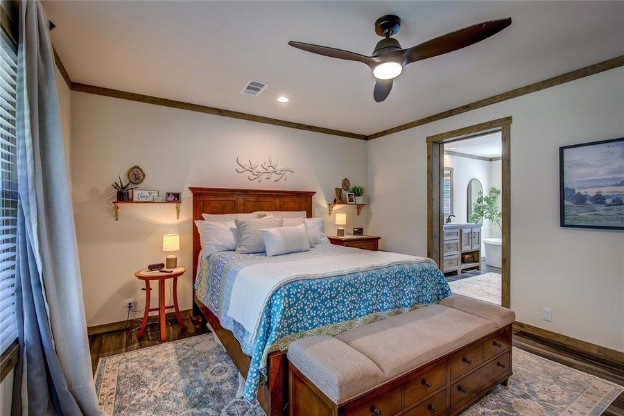 Bedroom featuring LVP floors, crown molding, a ceiling fan, recessed lighting, and connected bathroom