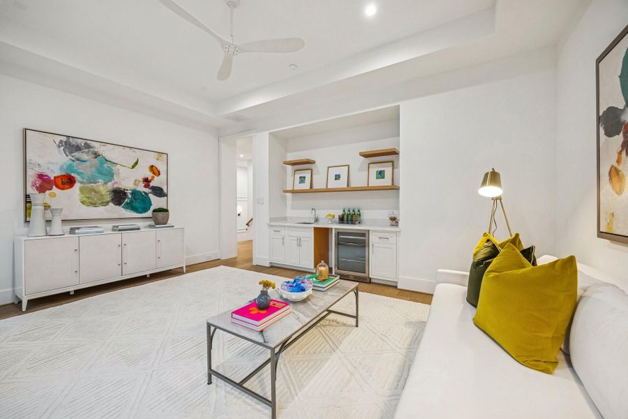 nother view of the upstairs media room which also features a wet bar Bar with a Slab Quartz Counter, Kraus Undermount Single Basin Stainless Steel Sink, Delta Single Lever Bar Faucet with a Swivel Spout. Zephyr Single Zone Beverage Cooler, Inset Shaker Style Cabinets and Drawers. There are also White Oak Floating Shelves with a Natural Stain. There is also pre-plumbing for an Ice Maker.