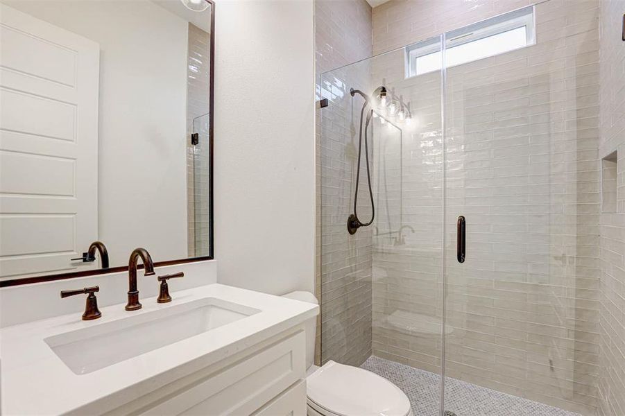 Bathroom with a shower stall and vanity