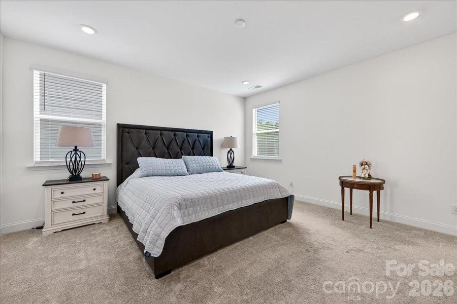 Primary bedroom with recessed lighting.