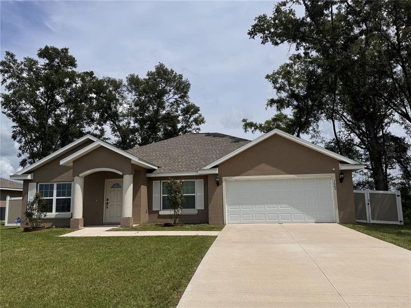 Front exterior of a new home in , Ocala, FL, highlighting curb appeal (Image 1).
