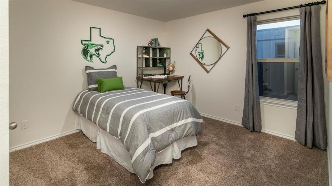 Bedroom with carpet floors and baseboards