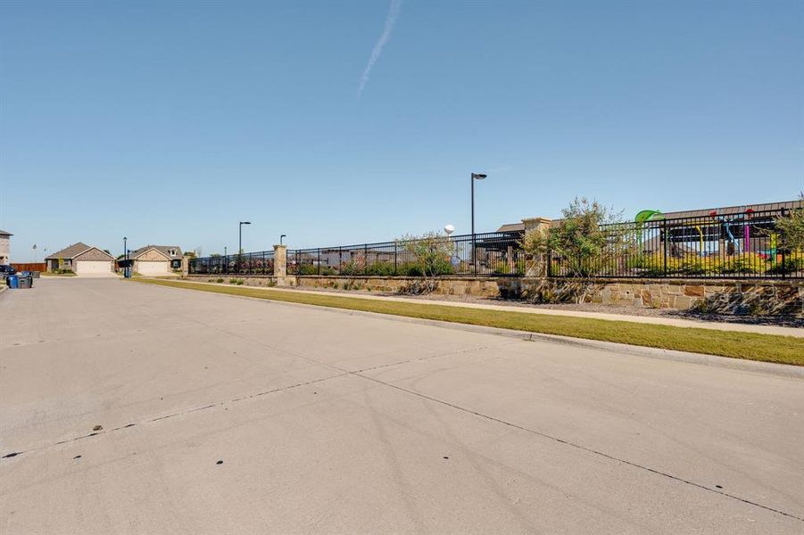 View of concrete street featuring sidewalks and curbs View of concrete street featuring sidewalks and curbs