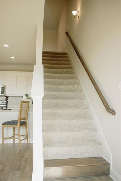 Stairway with hardwood / wood-style floors