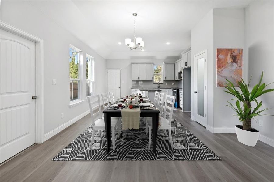 Game room featuring light wood-type flooring, sink, and a chandelier