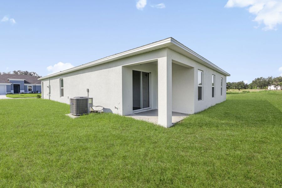 A white house with a grass yard.