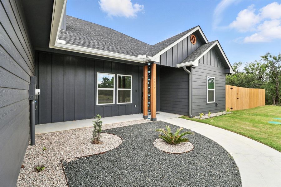 Entrance to property with board and batten siding and roof with shingles