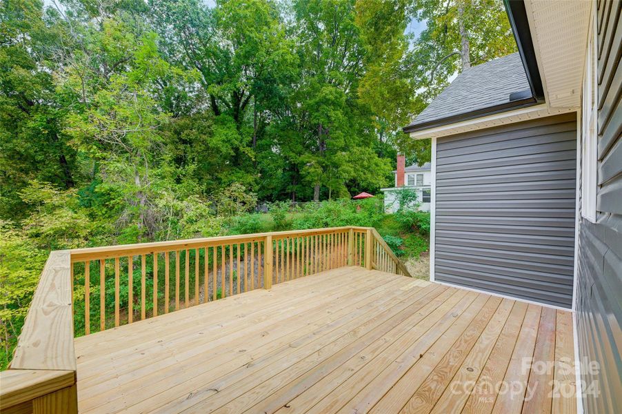 Back Deck overlooks private, wooded Backyard of the 0.755 acre lot