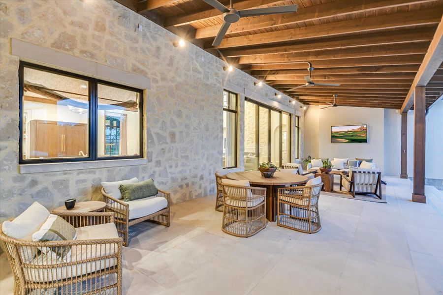 Dining space featuring plenty of natural light, a wood ceiling with exposed beams, and ceiling fan Dining space featuring plenty of natural light, a wood ceiling with exposed beams, and ceiling fan