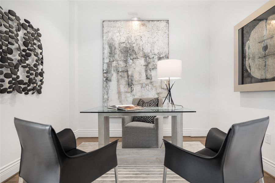 The secondary bedroom is currently styled as a home office, offering a quiet and versatile space with clean lines—ideal for remote work, study, or guest accommodations.