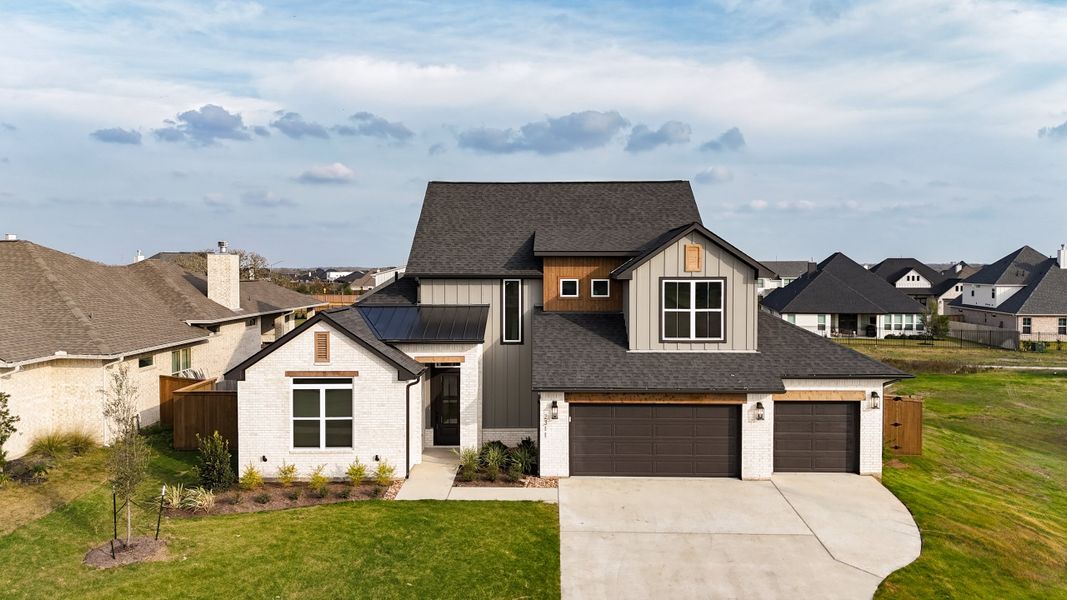 Front exterior of a new home in Greens Prairie Reserve, College Station, TX, highlighting curb appeal (Image 30).