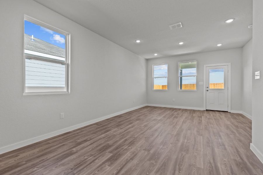 A room with a wood floor and white walls.