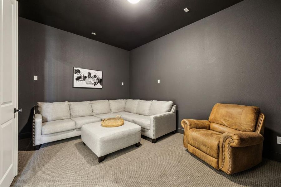 Living room with light colored carpet and baseboards