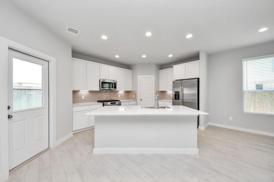 The extended counter area adds both practicality and style, making meal preparation a breeze. Every detail is thoughtfully designed to enhance the kitchen's functionality and aesthetic appeal. Sample photo of completed home with similar floor plan. Actual colors and selections may vary. The extended counter area adds both practicality and style, making meal preparation a breeze. Every detail is thoughtfully designed to enhance the kitchen's functionality and aesthetic appeal. Sample photo of completed home with similar floor plan. Actual colors and selections may vary.