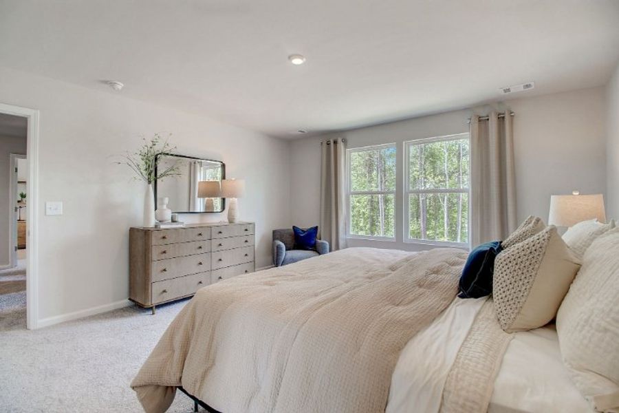 A bedroom with a bed and a dresser. A bedroom with a bed and a dresser.