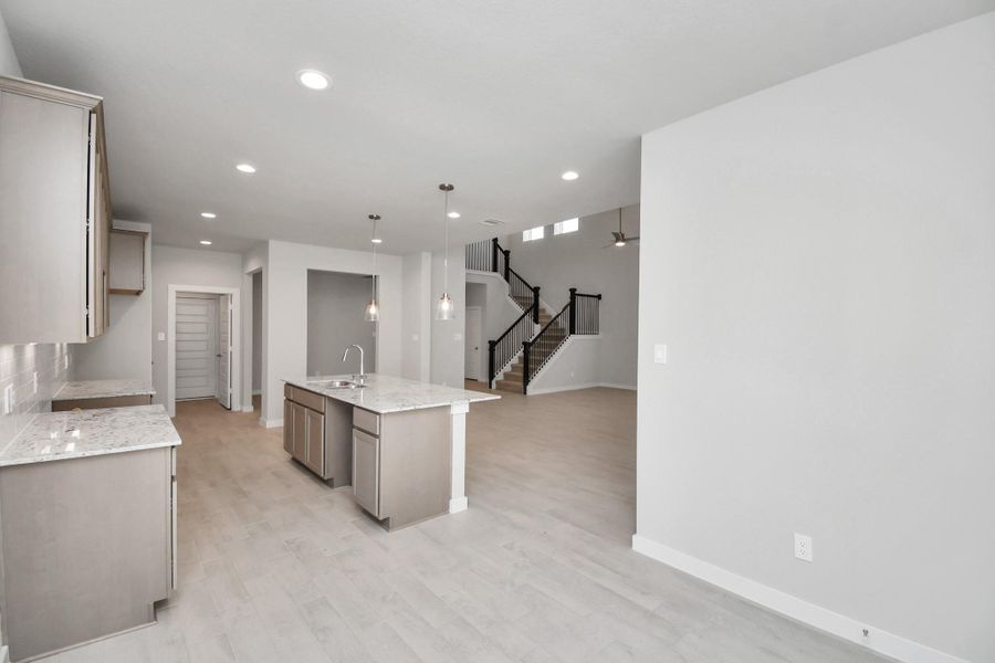 View from the breakfast area to the kitchen and dining room. Sample photo of completed home with similar floor plan. Actual colors and selections may vary. View from the breakfast area to the kitchen and dining room. Sample photo of completed home with similar floor plan. Actual colors and selections may vary.