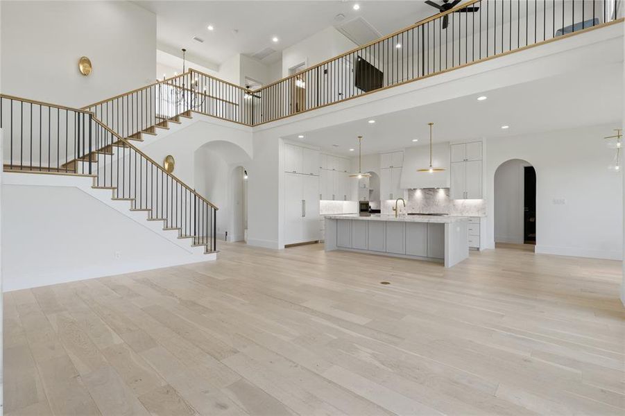 Spacious open-concept interior featuring light wood-finish flooring