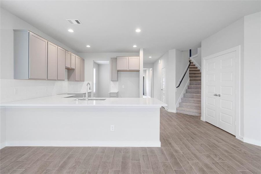 This kitchen is by far any chef’s dream! This spacious kitchen features high ceilings, stained wood cabinets, quartz countertops, SS appliances, modern tile backsplash, recessed lighting, extended counter space for breakfast bar, and a walk-in pantry all overlooking your huge family room.