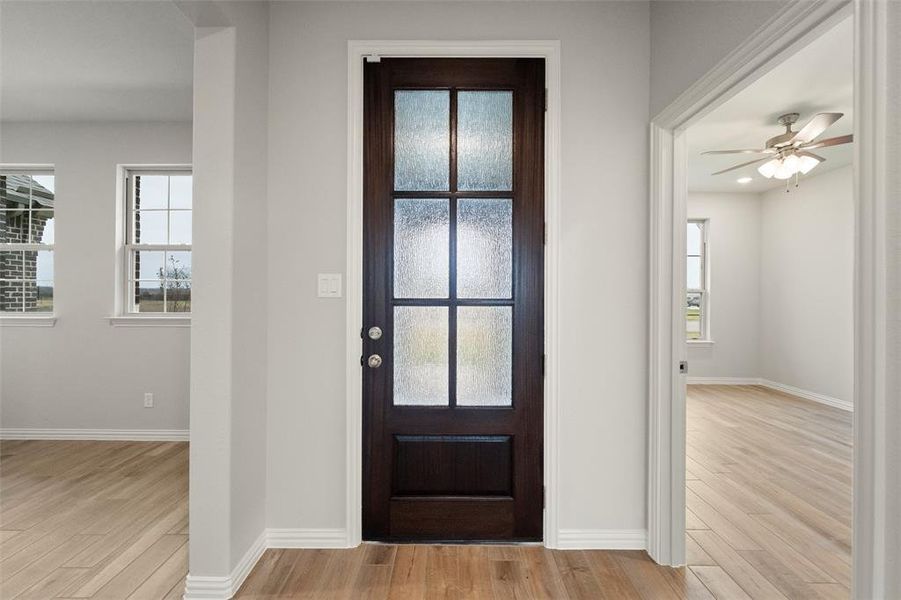 Foyer with light wood finished floors, healthy amount of natural light, and ceiling fan Foyer with light wood finished floors, healthy amount of natural light, and ceiling fan