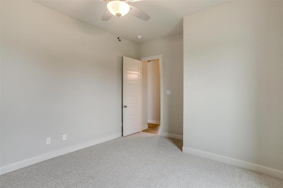 Spare room with light colored carpet and ceiling fan