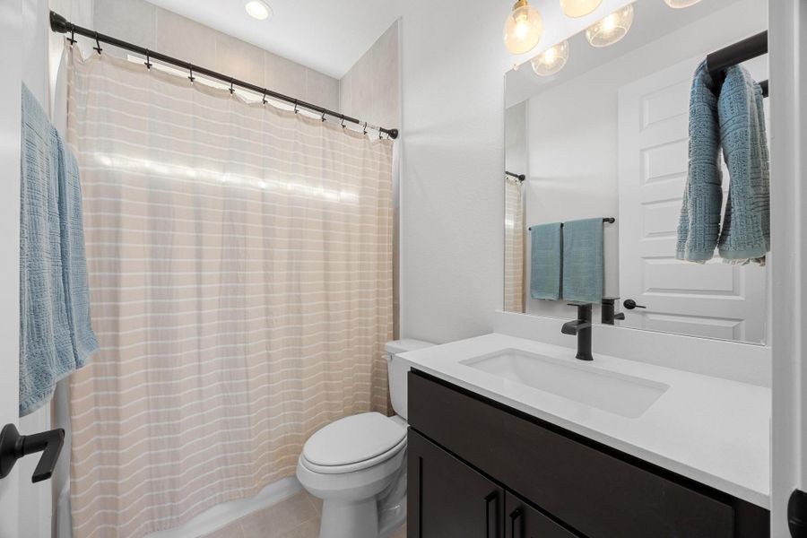 Bathroom with vanity, a shower with curtain, and recessed lighting