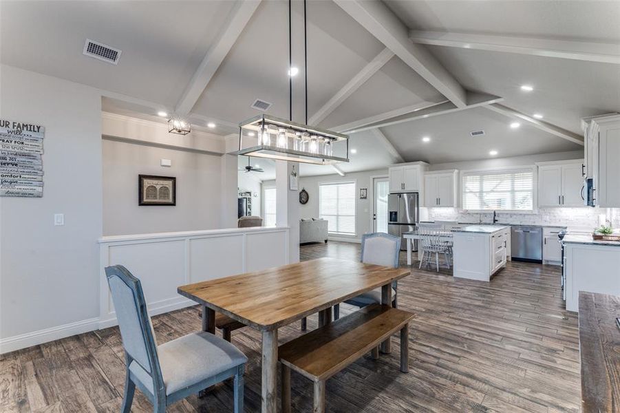 Dining room with dark wood-style flooring, a ceiling fan, and recessed lighting