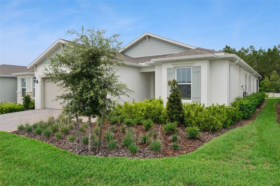 Front exterior of a new home in , Minneola, FL, highlighting curb appeal (Image 23). Front exterior of a new home in , Minneola, FL, highlighting curb appeal (Image 23).
