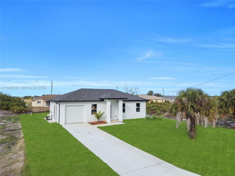 Front exterior of a new home in , Lehigh Acres, FL, highlighting curb appeal (Image 24).