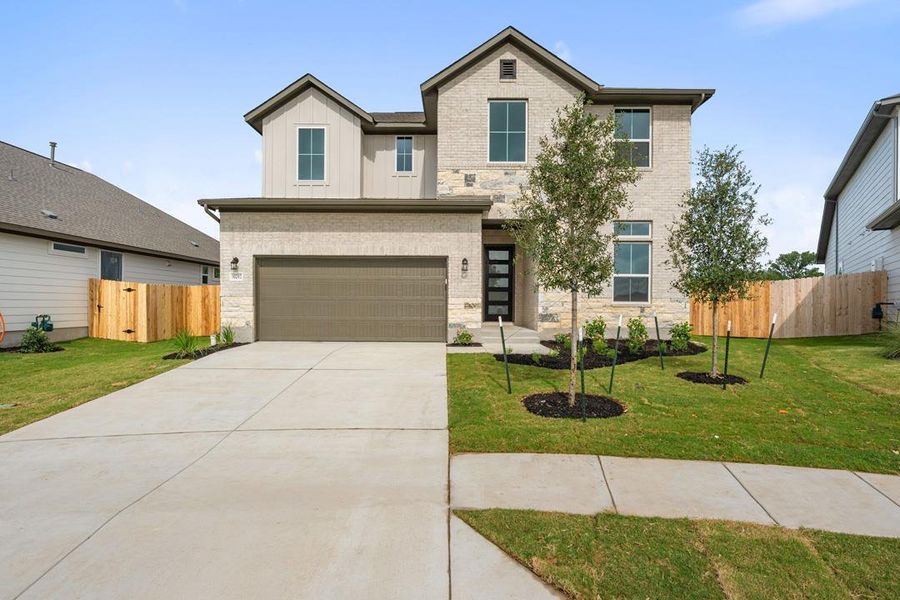 Front exterior of a new home in Lagos Reserve, Manor, TX, highlighting curb appeal (Image 21).