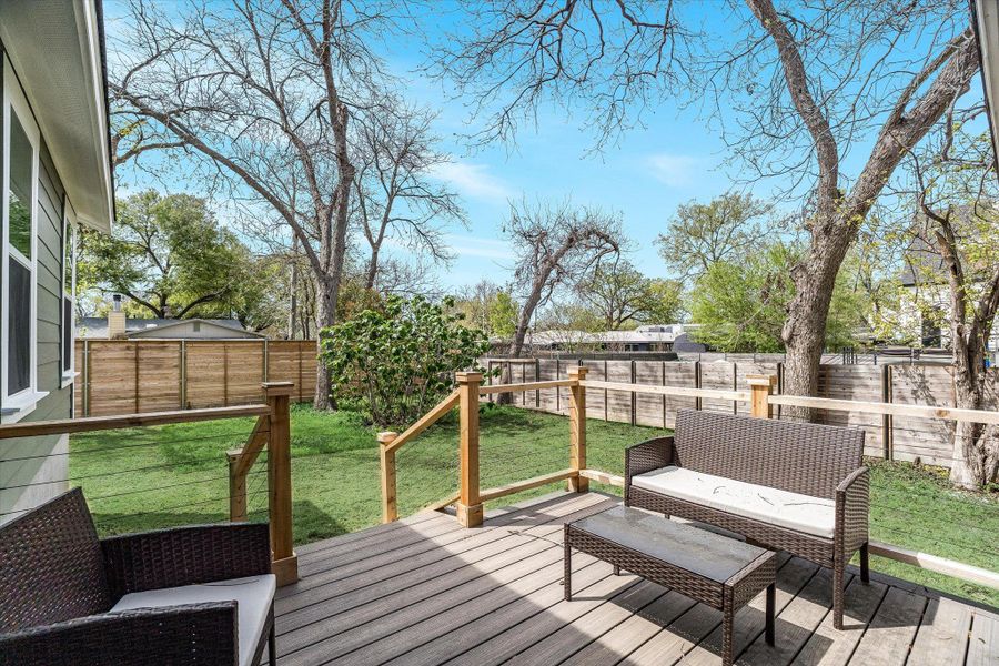 The property features a wooden deck with railing, overlooking a green lawn The property features a wooden deck with railing, overlooking a green lawn