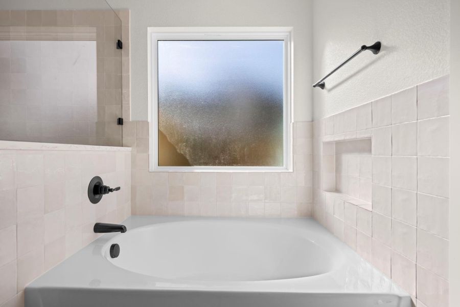 Indulge in relaxation with this inviting bathtub, perfect for unwinding after a long day.