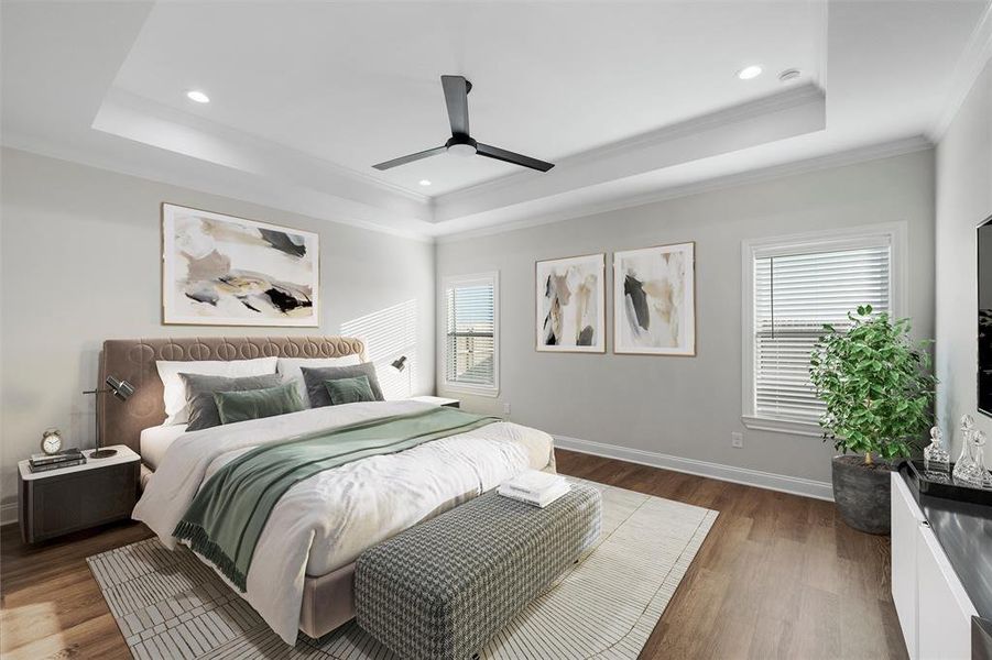 Bedroom with a raised ceiling, multiple windows, dark wood-style floors, ornamental molding, and recessed lighting Bedroom with a raised ceiling, multiple windows, dark wood-style floors, ornamental molding, and recessed lighting